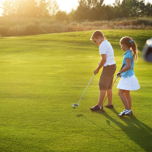 bigstock-Casual-Kids-At-A-Golf-Field-Ho-79961312